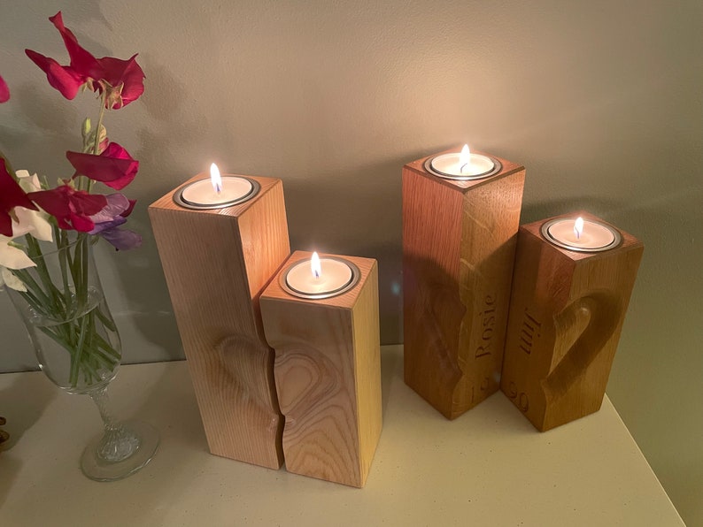 Two tall vertical rectangular square section pillar style candle holders. 3D engraved heart over the two pieces.  Recess on top of towers to sit tea light cups in. Engraved personalisation appears on the two inner faces to conceal the chosen wording.