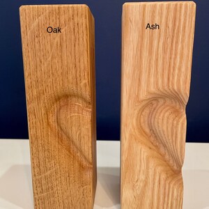 Image shows identical vertical tea light holders with 3D heart (half) for comparison of oak to ash woods.