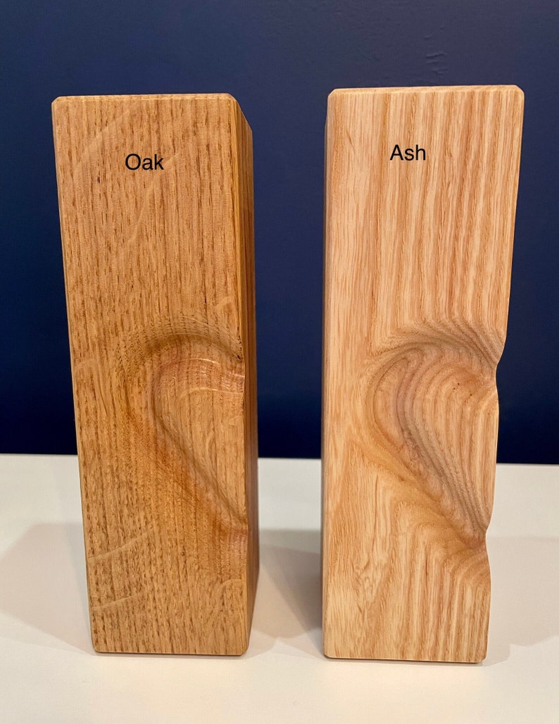 Image shows identical vertical tea light holders with 3D heart (half) for comparison of oak to ash woods.