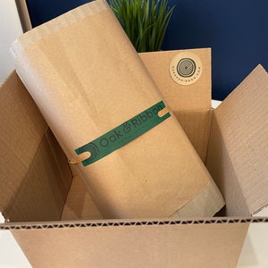 Proud to show our eco friendly brand packaging. How your order will arrive.  Outer cardboard box, item wrapped in recycled corrugated cardboard, then a layer of kraft paper tied together with raffia ribbon with our handmade Oak & Ribbon green label.