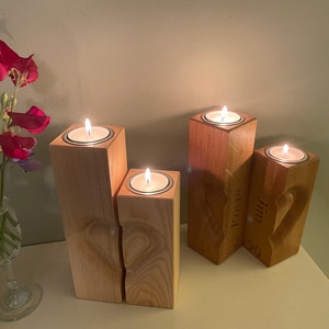 Two tall vertical rectangular square section pillar style candle holders. 3D engraved heart over the two pieces.  Recess on top of towers to sit tea light cups in. Engraved personalisation appears on the two inner faces to conceal the chosen wording.