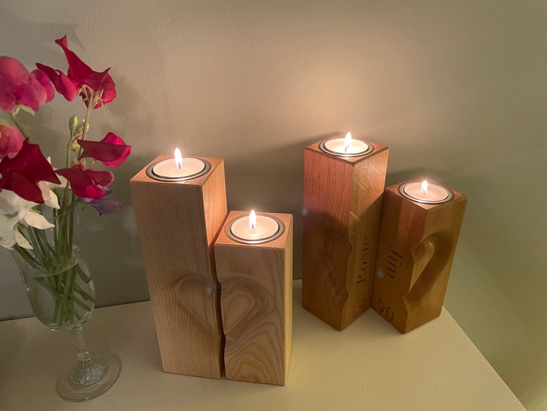 Two tall vertical rectangular square section pillar style candle holders. 3D engraved heart over the two pieces.  Recess on top of towers to sit tea light cups in. Engraved personalisation appears on the two inner faces to conceal the chosen wording.