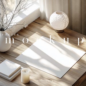 May include: A mockup scene featuring a white vase with branches, a textured orb lamp, a stack of books, a candle, and a blank poster on a wooden table. The text "POSTER mockup" is visible. Soft sunlight streams in from a window.