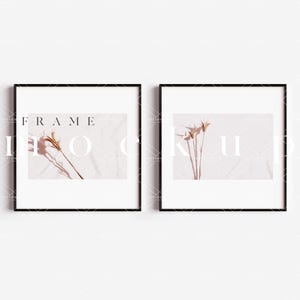 May include: Two black framed pictures with white mats hanging on a white wall. The picture on the left has a dried flower arrangement on a light pink background. The picture on the right has a dried flower arrangement on a white background. The text "FRAME MOCKUP" is visible in the image.