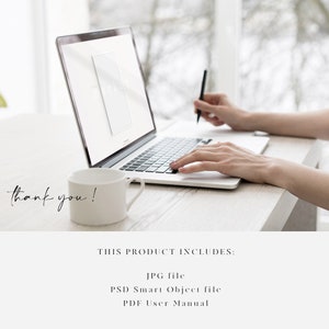 May include: A person working on a laptop computer with a white mug on a white desk. The laptop screen shows a mockup of a product. The text "THIS PRODUCT INCLUDES: JPG file PSD Smart Object file PDF User Manual" is visible on the screen.