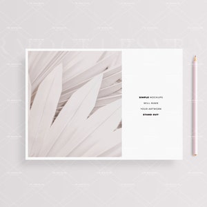 May include: A white card with a white and gray abstract image on the left side and text on the right side that reads "SIMPLE MOCKUPS WILL MAKE YOUR ARTWORK STAND OUT!" A pink pencil is on the right side of the card.
