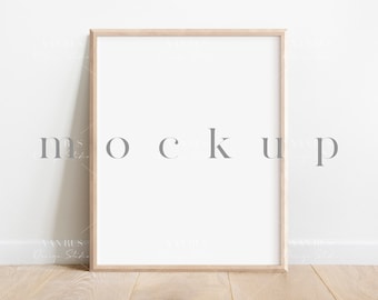 May include: A light wood frame mockup with a white background. The frame is sitting on a light wood floor in front of a white wall.