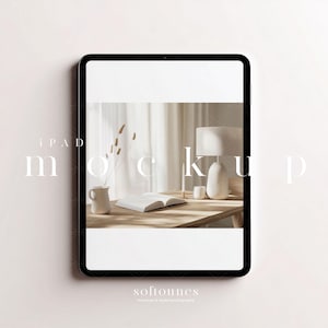 May include: iPad mockup with a minimalist design. The screen shows a styled interior scene with a lamp, vase, and open book on a wooden table. The text "iPAD mockup" and "softounes" are visible.