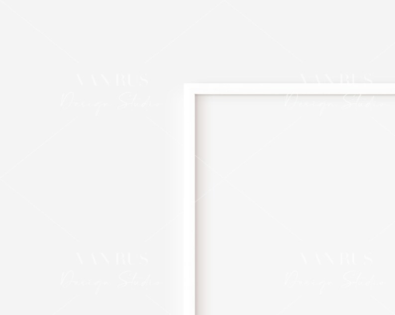 May include: A white picture frame with a white mat is hanging on a white wall.