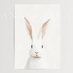 May include: A white rabbit with long ears and pink tips. The rabbit is looking directly at the viewer with a soft, gentle expression. The background is a simple white.