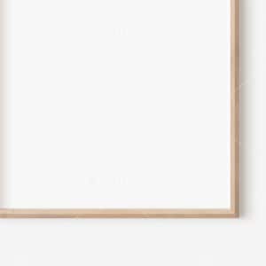 May include: A simple, light wood picture frame with a white background.