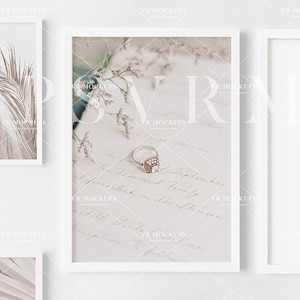 May include: A collection of framed prints with a minimalist aesthetic. The prints feature various natural elements, including dried grasses, plants, and a couple embracing in a desert landscape. The frames are white and have a simple design.