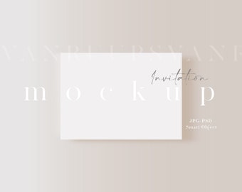 May include: A white blank card mockup with the word "Invitation" written in cursive on the card. The card is on a light beige background.
