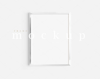 May include: A white picture frame mockup with the text "FRAME MOCKUP" in a light brown font.