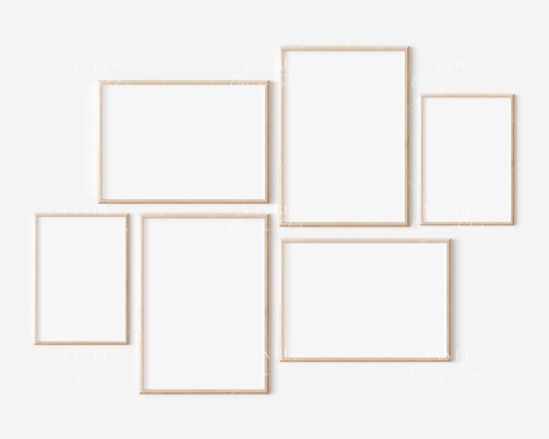 May include: Five empty picture frames of various sizes are arranged on a white wall. The frames are made of light wood and have a simple, modern design.
