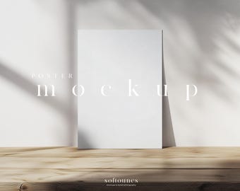 May include: A white poster mockup leaning against a white wall, with the text "POSTER mockup" in a minimalist font. The poster rests on a wooden surface, with shadows from a plant adding depth. The bottom right corner has the text "softounes mockups & styled photography."