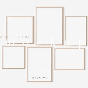 May include: Five wood picture frames of various sizes are arranged on a white wall. The frames are all the same colour, a light brown wood.