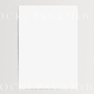 May include: A blank white sheet of paper, perfect for writing, drawing, or printing. The paper is lying flat on a light gray surface.