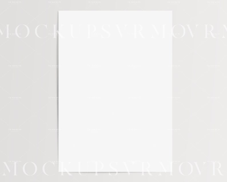 May include: A blank white sheet of paper, perfect for writing, drawing, or printing. The paper is lying flat on a light gray surface.