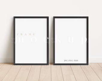May include: Two black picture frames with white mats, hanging on a white wall. The frames are empty and ready for your photos or artwork.