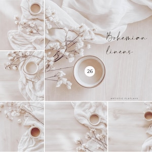 May include: A flat lay image of a white background with white fabric, dried flowers, and small white bowls. The text "Bohemian linens" is written in black cursive. The number 26 is written in black on a white bowl. The text "Artistic Flatlays" is written in black at the bottom of the image.