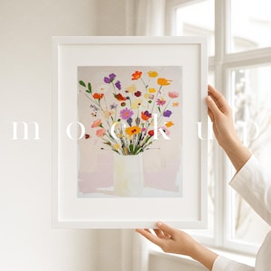 May include: A white framed print of a colorful floral arrangement in a white vase. The flowers are a mix of pink, purple, yellow, orange, and red.