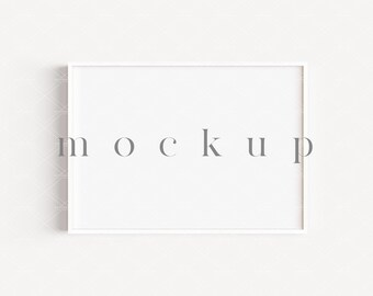 May include: A white rectangular picture frame with the word "mockup" in gray letters. The frame is centered on a white background with a subtle geometric pattern.