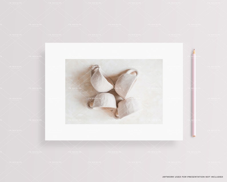 May include: Four white ceramic cups arranged in a circle on a light beige surface. The cups are slightly tilted and have a simple, minimalist design.