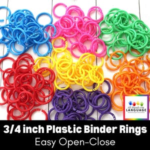 May include: A large pile of 3/4 inch plastic binder rings in six different colors: blue, red, yellow, green, orange, and purple. The rings are easy to open and close. "All Hands On Language" is printed on a small sticker in the lower right corner of the image.