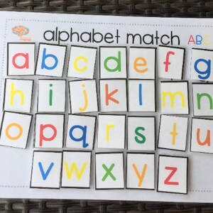 May include: Alphabet match game with colorful letters on white squares with black borders. The letters are arranged in alphabetical order.