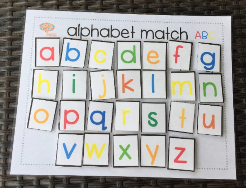 May include: Alphabet match game with colorful letters on white squares with black borders. The letters are arranged in alphabetical order.