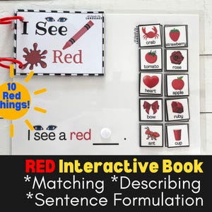 May include: A red interactive book for children with the text "I See Red" and "10 Red Things!"  The book includes a matching activity with images of red objects such as a crab, strawberry, tomato, rose, heart, apple, bow, ruby, ant, and cup. The book also includes a sentence formulation activity with the text "I see a red ____."