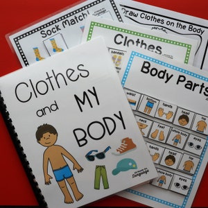 May include: A set of educational activity books for children, featuring a colorful illustration of a boy wearing clothes and a book titled "Clothes and My Body". The books include activities like matching socks, drawing clothes on the body, and identifying body parts.