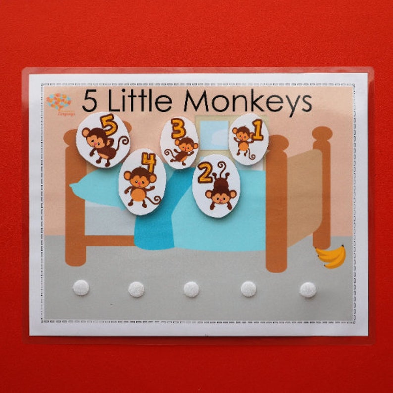 May include: A learning game for kids featuring five monkeys on a bed with numbers 1 through 5. The game is designed to help children learn to count.