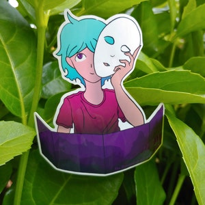 May include: A sticker depicting an anime-style character with teal hair and a pink shirt holding a white mask. The sticker has a purple and black base, set against a backdrop of green leaves.