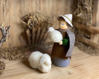 Shepherd with a lamb in his arms and a felted sheep for the Christmas nativity scene, Waldorf style