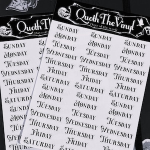 May include: Two sheets of black and white vinyl stickers featuring the days of the week in a decorative font. The header on each sheet reads Quoth The Vinyl Days of the week with a raven icon. Each sheet contains multiple columns of labels.