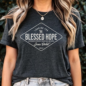 May include: A dark grey t-shirt with a white diamond-shaped graphic that says "Looking for the Blessed Hope & the glorious appearing of the great God & our Saviour Jesus Christ Titus 2:13"