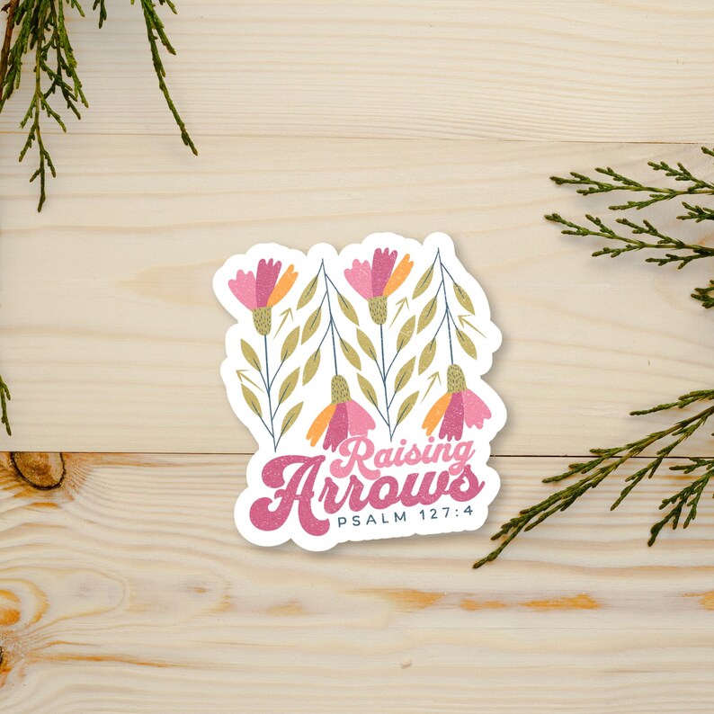 May include: A sticker with a floral design and the text "Raising Arrows Psalm 127:4". The flowers are pink, orange, and yellow.
