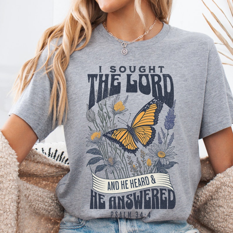 May include: A gray t-shirt with a butterfly graphic and the text "I sought the Lord and he heard & he answered Psalm 34:4".