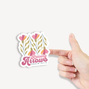 May include: A sticker with a floral design and the text "Raising Arrows Psalm 127:4".