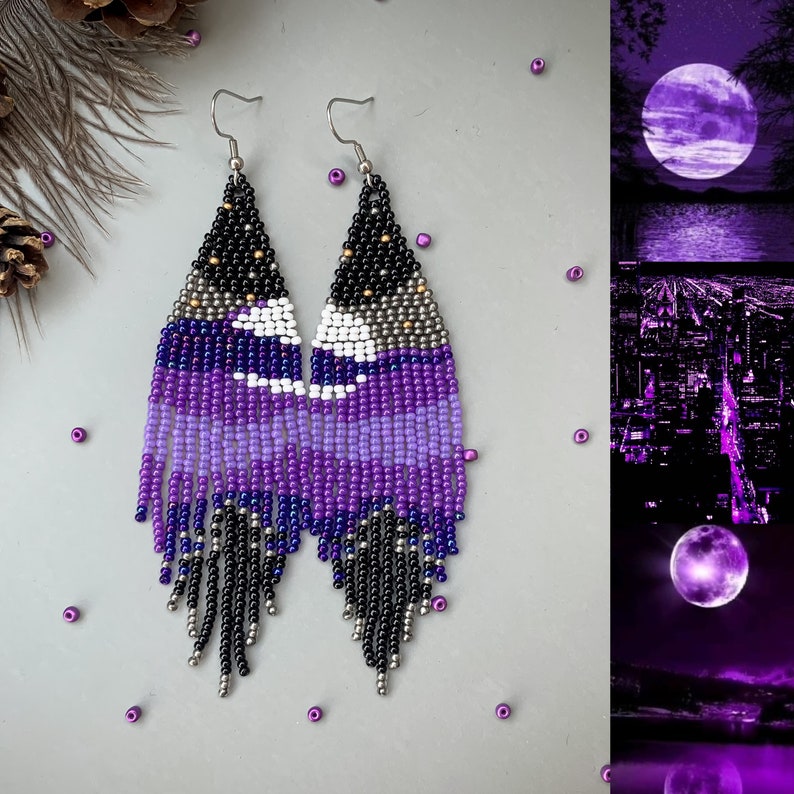 May include: Handmade beaded earrings in shades of purple, black, silver, and white. The earrings feature a geometric design with a fringe at the bottom. The earrings are designed with a hook closure. The earrings are a unique accessory.