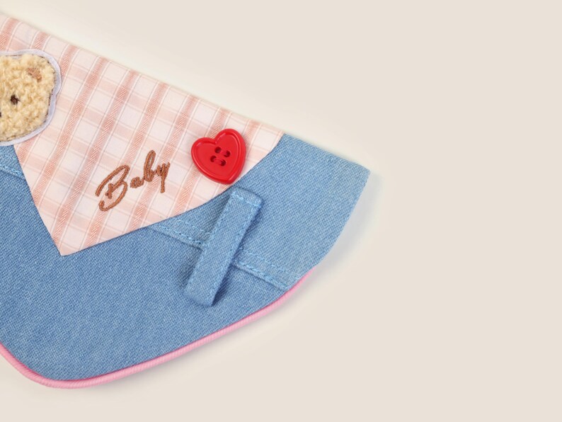May include: A blue denim and pink gingham dog collar with a red heart button and the word "Baby" embroidered on it.