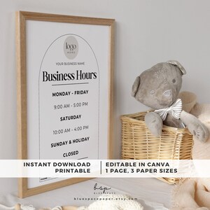 May include: A printable business hours sign with a modern design. The sign is in a white frame with a light wood finish. The sign has a black and white color scheme and features a simple arch design. The text on the sign reads "Business Hours" and lists the hours of operation for each day of the week. The sign also includes the text "Instant Download Printable" and "Editable in Canva 1 Page, 3 Paper Sizes".