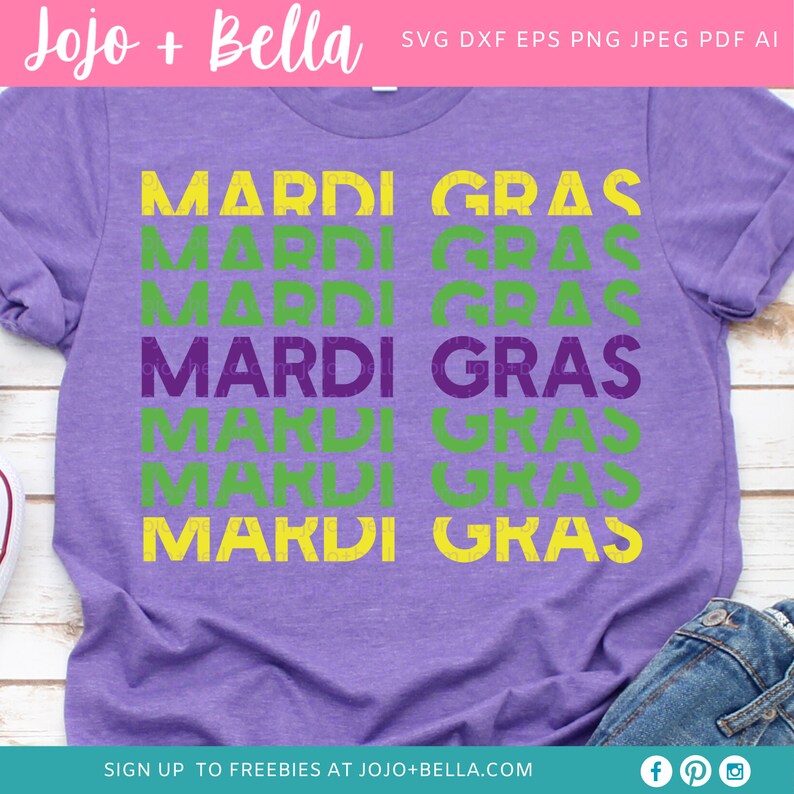 May include: Purple t-shirt with the text "Mardi Gras" repeated six times in green and yellow lettering. The text is stacked vertically and has a distressed, vintage look.