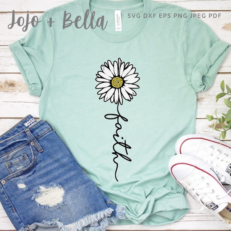 May include: A light blue t-shirt with a white daisy and the word "faith" written in a cursive font.