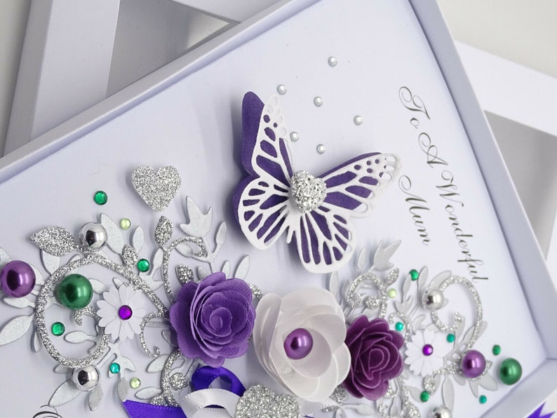 May include: A handmade card with a purple butterfly, flowers, and silver glitter. The card says "To A Wonderful Mum".