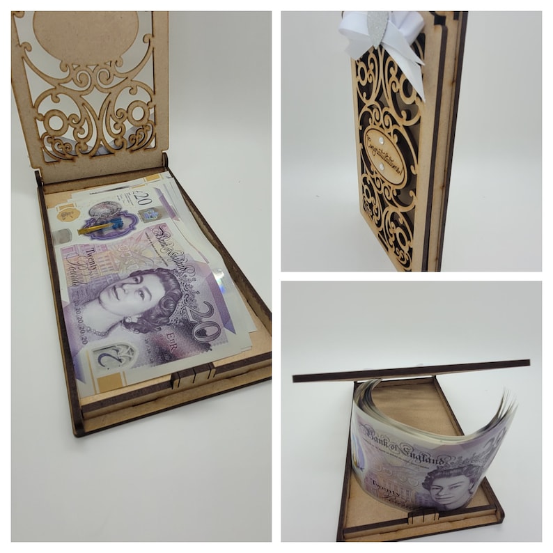 May include: A wooden money box with an open lid, filled with twenty-pound notes. The box has an ornate, laser-cut design on the lid and front. The words "Congratulations" are visible on the front of the box. A white bow is attached to the top.