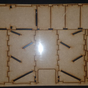 May include: A wooden craft kit for building a model house. The kit includes pre-cut pieces of wood, along with instructions and tools.