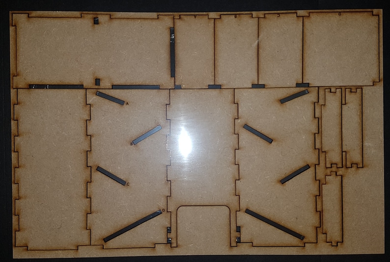 May include: A wooden craft kit for building a model house. The kit includes pre-cut pieces of wood, along with instructions and tools.